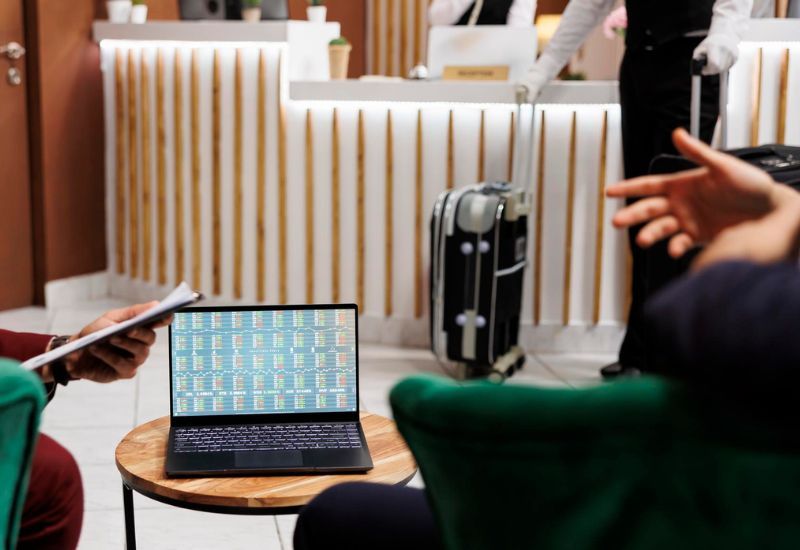 A hotel hallway with a laptop on a table